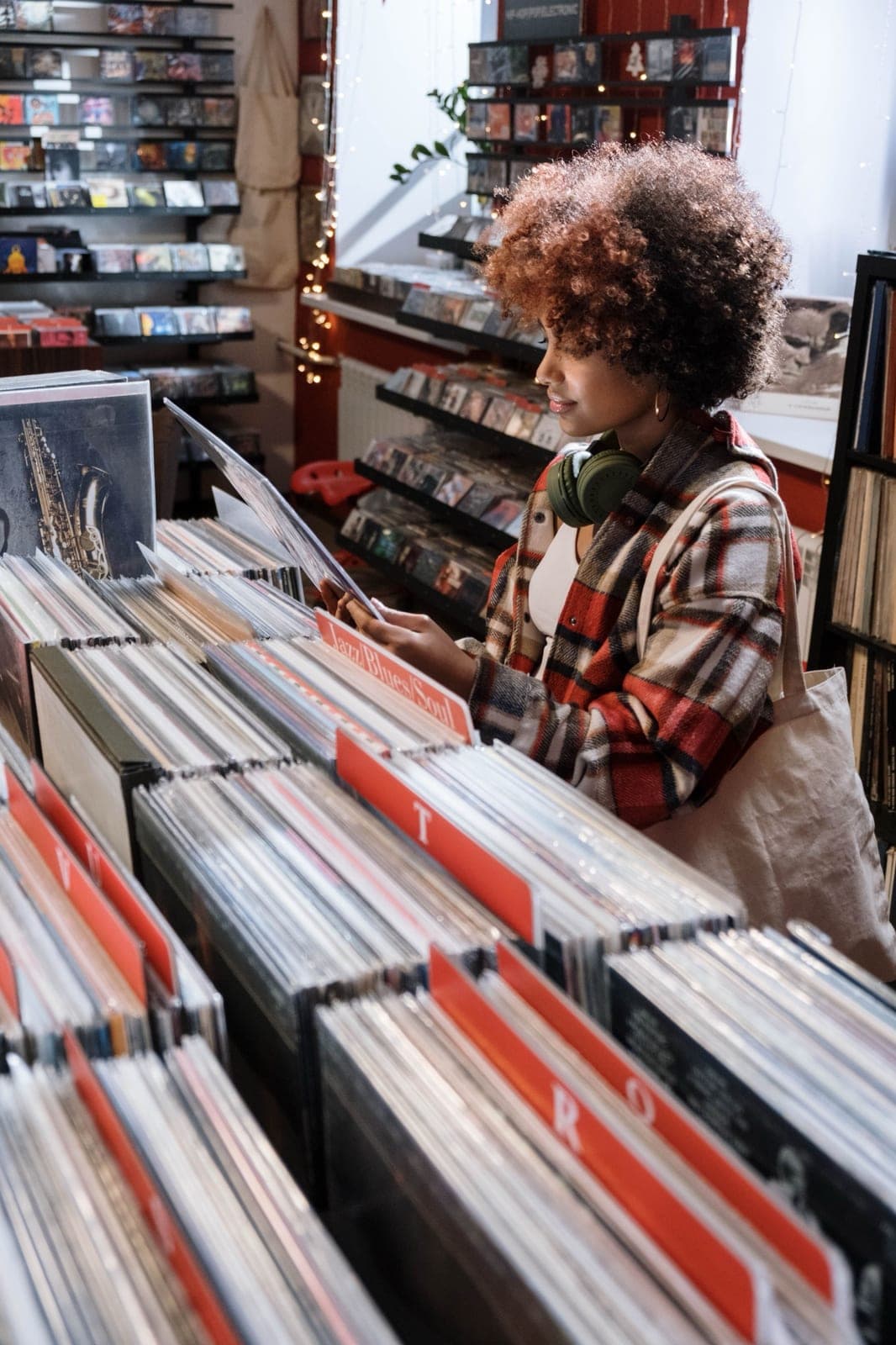 A woman browsing vinyl records in a record shop